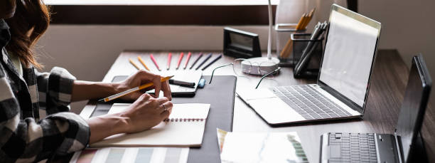 istock Graphic designer working with sketching logo design at office. Banner design 1495292607