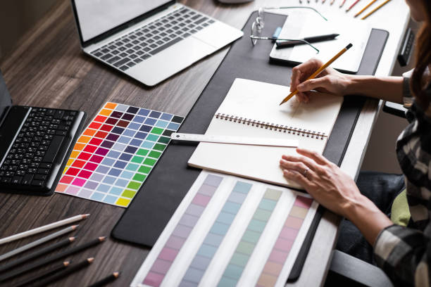 Graphic designer working with sketching logo design at office. stock photo