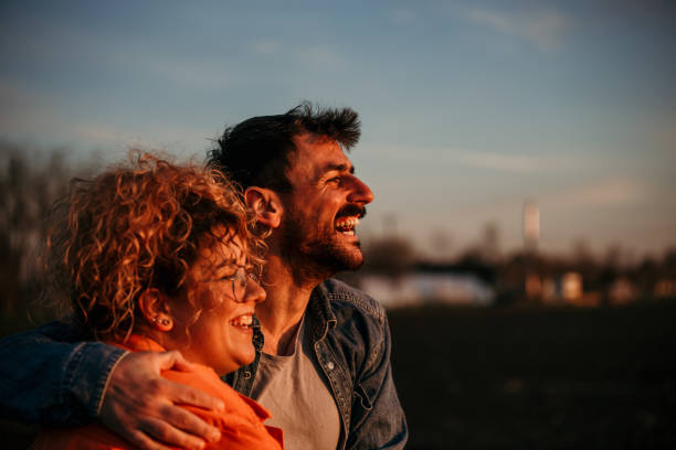 istock Smiling couple enjoying sunset 1495292741