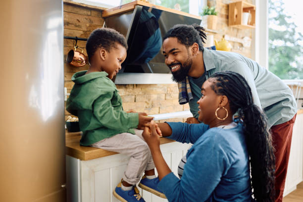 istock Happy black parents talking to their small son in the kitchen. 1495293191