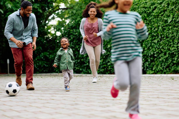 istock Cheerful black boy having fun while playing with his family outdoors. 1495293791