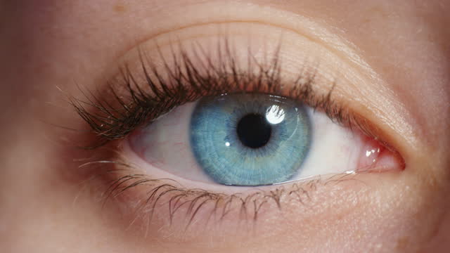 close up beautiful blue eye opening human iris macro natural beauty
