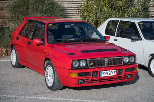 Torrelles de Llobregat, Spain – February 18, 2023: A red-colored Lancia Delta HF parked on the street