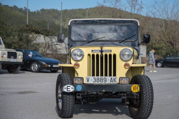 front view of a classic off-road jeep ebro cj-3b-e bravo s in yellow color - car individuality military 4x4 imagens e fotografias de stock