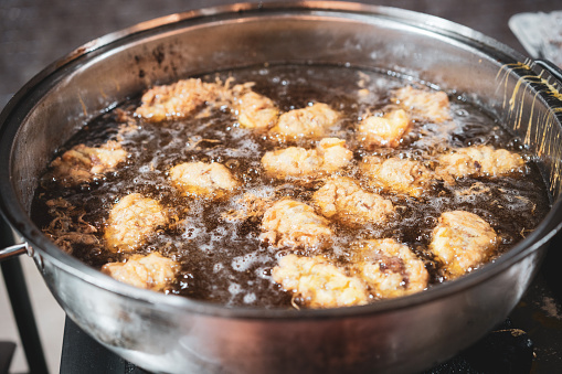 Shot of meatballs frying in the pan