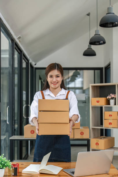 istock Woman startup small business entrepreneur works with boxes in a her workplace. Ecommerce business idea 1495307521