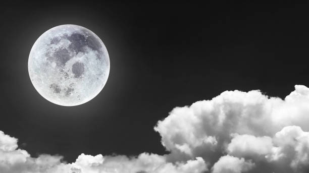 istock Night scene image of bright and beutiful full moon on dark sky with blurry bright cloudscape for nature and travel transportation background. 1495308509
