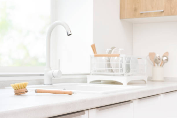 istock Eco-friendly cleaning brush on kitchen sink and drying dishes background 1495311778