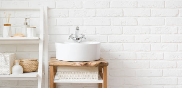 istock Bathroom sink and ladder shelf on white brick wall background 1495311790