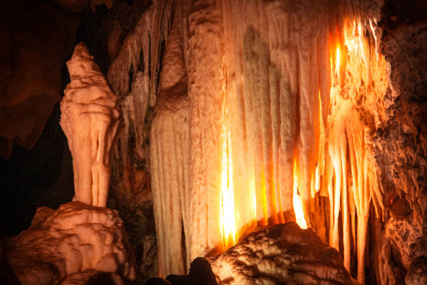Horizontal landscape photo of extraordinary limestone rock formations underground lit up by lights inside the Wombeyan Caves in the countryside near Goulburn, NSW.