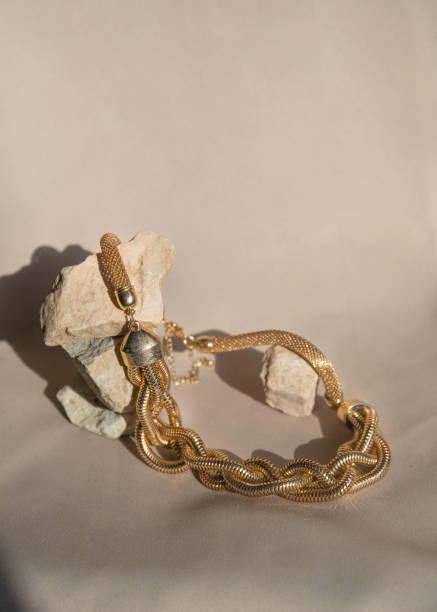 istock Still life with golden necklace over beige background. Minimalistic abstract composition. 1495314038