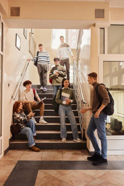 istock Happy high school students talking in a hallway. 1495320474
