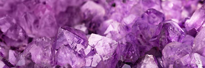 Multicolored crystals with glowing particles inside, close-up, selective focus.