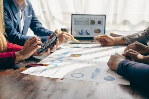 istock Meet with colleagues to discuss sales analysis in financial reports with graph papers. Financial accounting and business strategy planning related to sales analysis in company marketing reports. 1495320747
