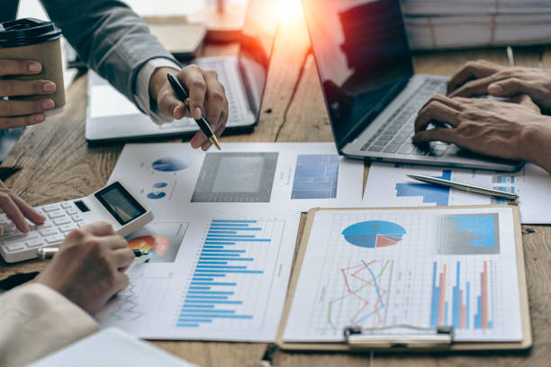 istock Meet with colleagues to discuss sales analysis in financial reports with graph papers. Financial accounting and business strategy planning related to sales analysis in company marketing reports. 1495320768