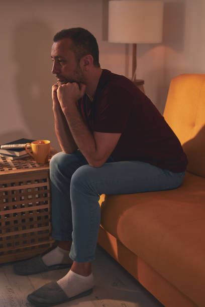 istock Bored man with lethargy and apathy sitting at home alone. 1495320848