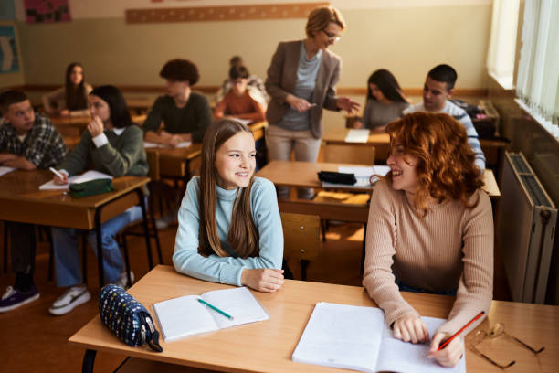 istock Happy female students talking on a class at high school. 1495320981