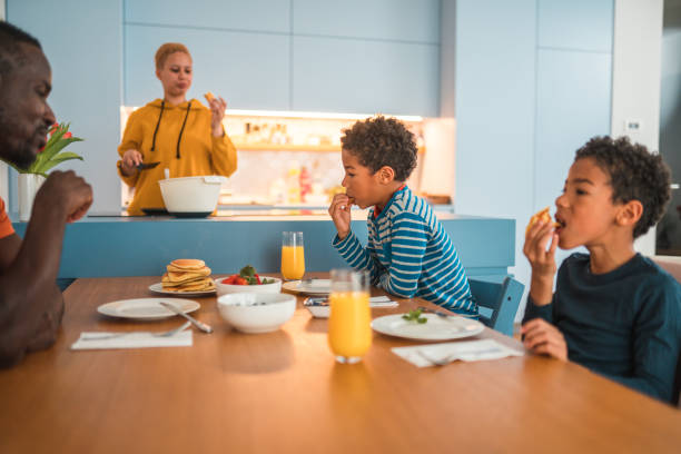 istock Happy Mixed-Race Family Having Breakfast at Home 1495322295
