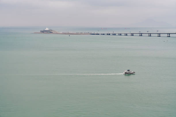 A tourist ferry sailing nearby the Hong KongZhuhaiMacau Bridge. South China Sea. Hong Kong.