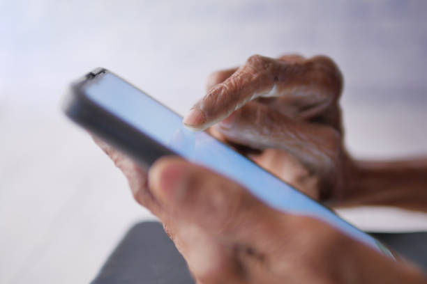 istock senior women hand using smart phone close up 1495323209