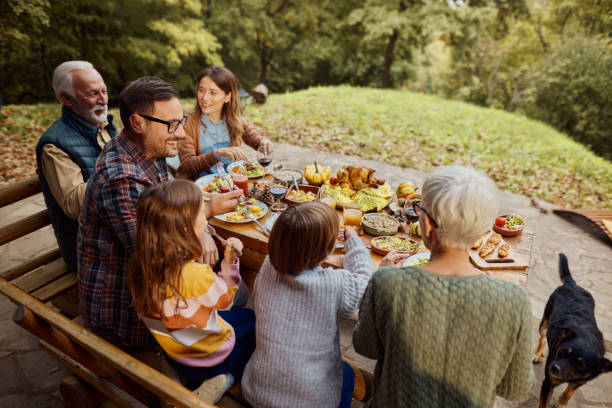 istock Happy extended family talking during a meal on a patio. 1495324017