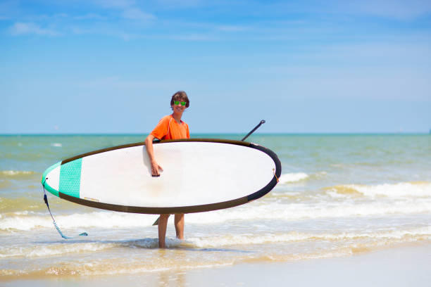 istock Man on stand up paddle. Water and beach sport 1495329213