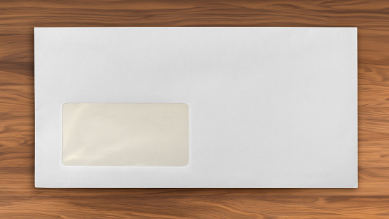 Blank postal envelope with address window on wooden desktop