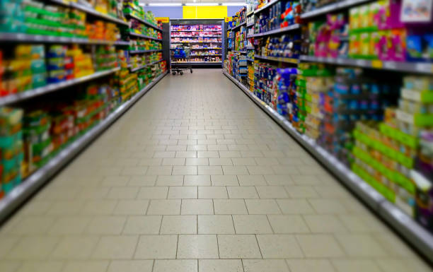 istock View between the shelfs into a supermarket 1495331571