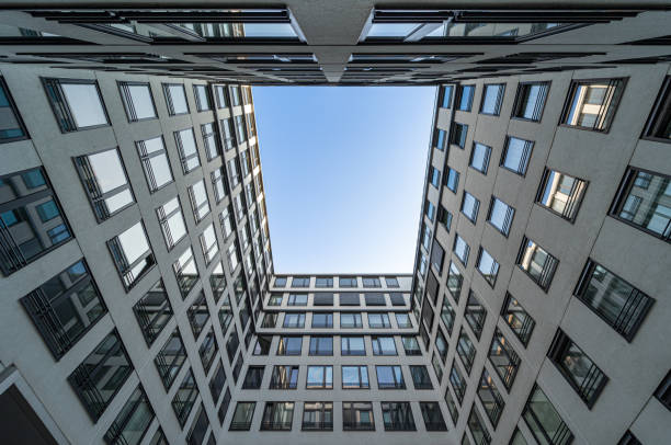 istock Low angle view of modern office building against clear blue sky 1495333662