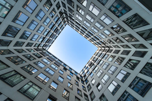 istock Low angle view of modern office building against clear blue sky 1495333672