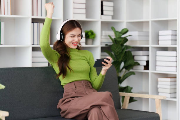 istock Attractive Asian woman resting comfortable living room and using mobile phone, Relax, Sofa, Lifestyle 1495336501