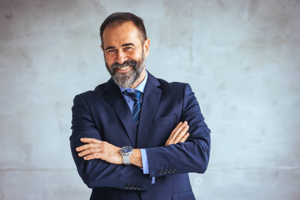 istock Mature cheerful executive businessman at workspace office. 1495337027