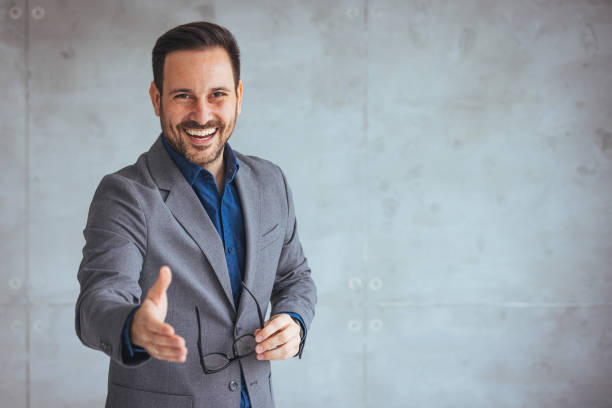 istock Businessman reaching out his hand for a handshake. 1495337061