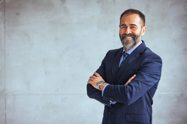 Portrait of smiling ceo at modern office workplace in suit stock photo