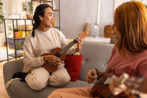 istock Two women playing ukuleles and singing at home 1495337074