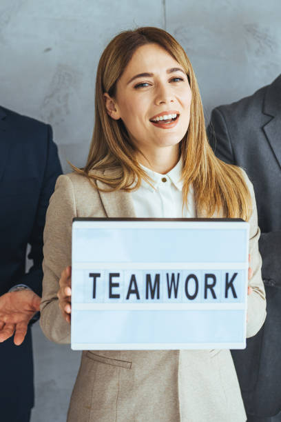 istock Team leader holding sign ''teamwork'' in hands 1495338483