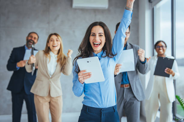 istock Smiling multiethnic colleagues celebrate shared business success or victory in office 1495338620