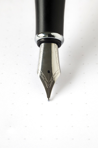 vertical close up of a simple silver fountain pen nib