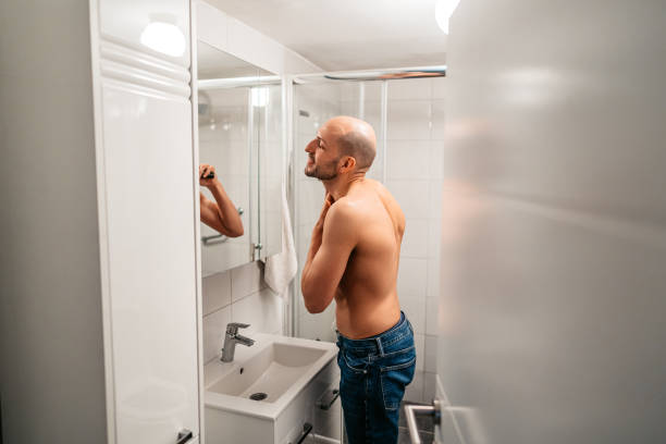 istock Young Man Shaving His Beard In The Bathroom 1495340413