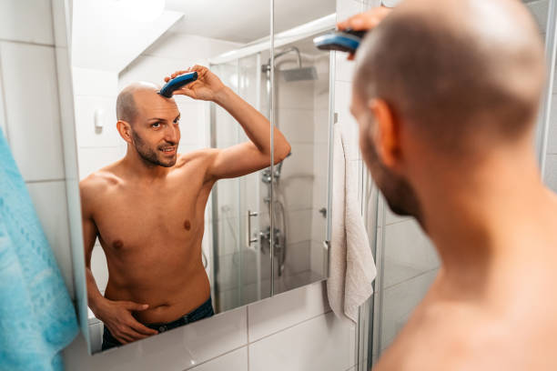 istock Young Man Shaving His Head In The Bathroom 1495340442