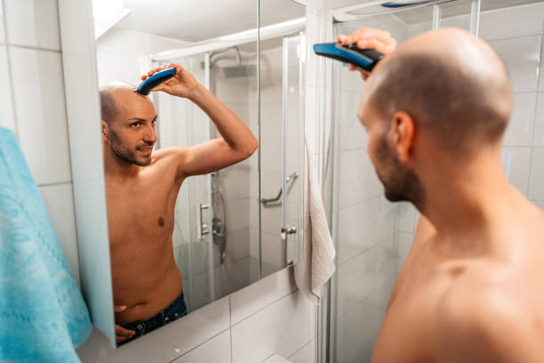 istock Young Man Shaving His Head In The Bathroom 1495340794