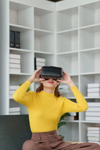 istock Attractive Asian woman resting comfortable living room and using AR glasses, Relax, Sofa, Lifestyle, Virtual Reality Headset 1495340809