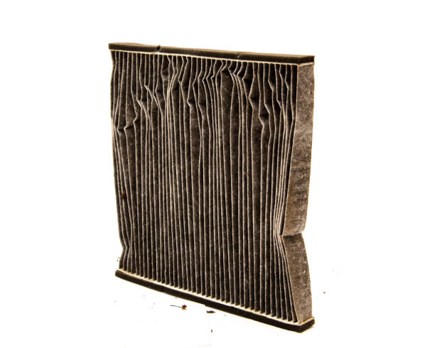Side view used dirty auto cabin air filter made of fiber paper cotton with debris clogged and polluted air flow isolated on white background stock photo