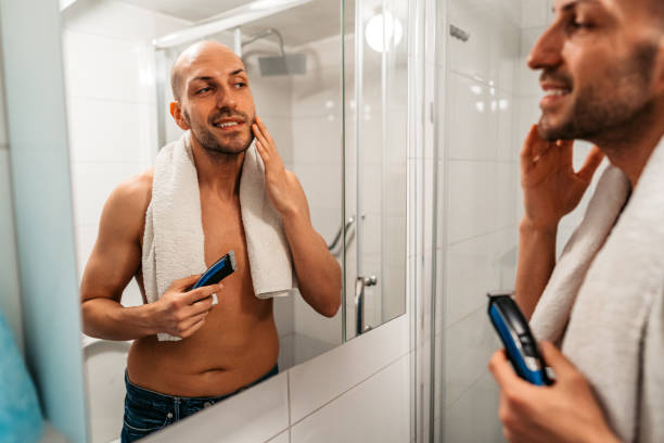 istock Young Man Shaving His Beard In The Bathroom 1495341150