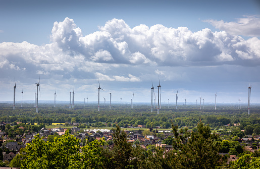 Viewpoint from the so-called teutoburgerwalt, over the village of HÃ¶rstel-Riesenbeck and the wind turbines for generating wind energy, surrounding the tecklenburger landscape, Germany