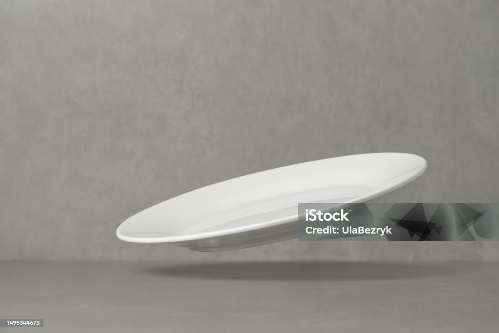 Table Fall Down Empty White Plate Falling On The Table Levitation Flying Saucer Stock ...