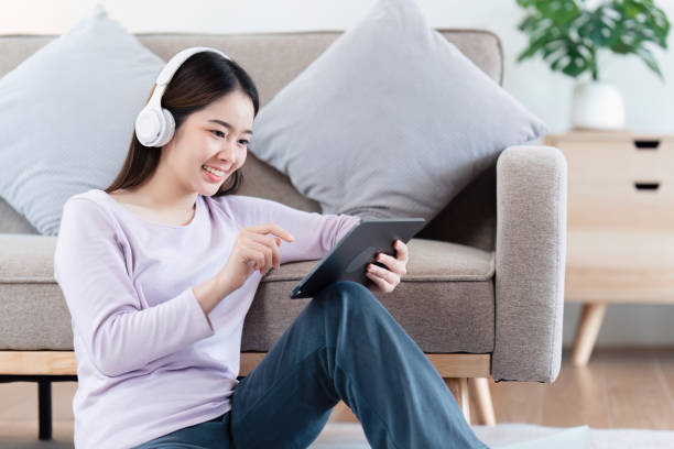 istock Attractive Asian woman resting comfortable living room and using digital tablet, Relax, Sofa, Lifestyle 1495351851