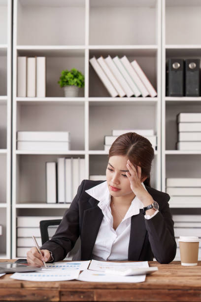 istock Employee feeling tired stressed with her work in the office, sad working woman overworked overtime, business woman upset with financial document 1495352272