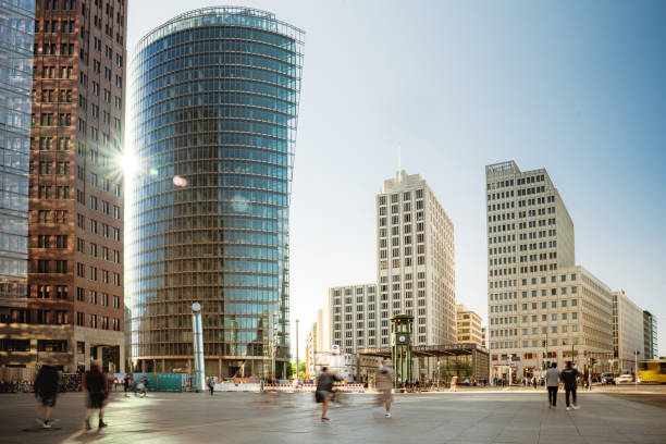 motion blurred people  walking at potsdamer platz in berlin in the  afternoon sun