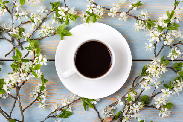 istock Black coffee and cherry blossom branches 1495354255